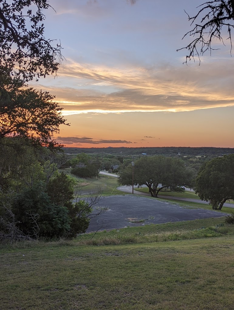 Panoramic view of a lush green golf course at The Club at Rebecca Creek. Smooth