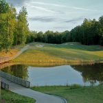 Panoramic view of a lush green golf course at The Club at Viniterra. Smooth