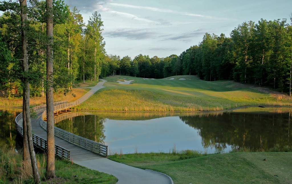 Panoramic view of a lush green golf course at The Club at Viniterra. Smooth