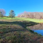 Panoramic view of a lush green golf course at The Connecticut Golf Club. Smooth