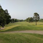 Panoramic view of a lush green golf course at The Country Club of Arkansas. Smooth