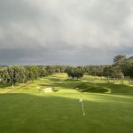 Panoramic view of a lush green golf course at The Country Club of Birmingham. Smooth