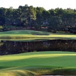 Panoramic view of a lush green golf course at The Country Club of North Carolina. Smooth