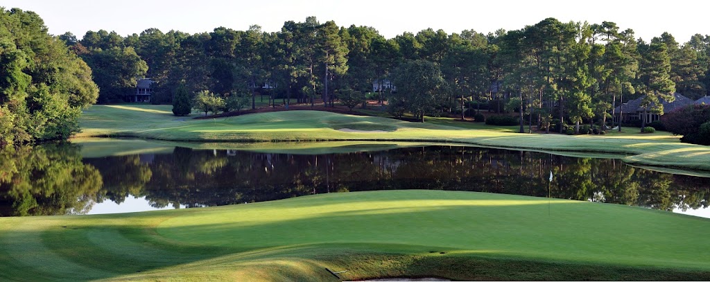 Panoramic view of a lush green golf course at The Country Club of North Carolina. Smooth