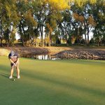 green grass with the flag in the hole.