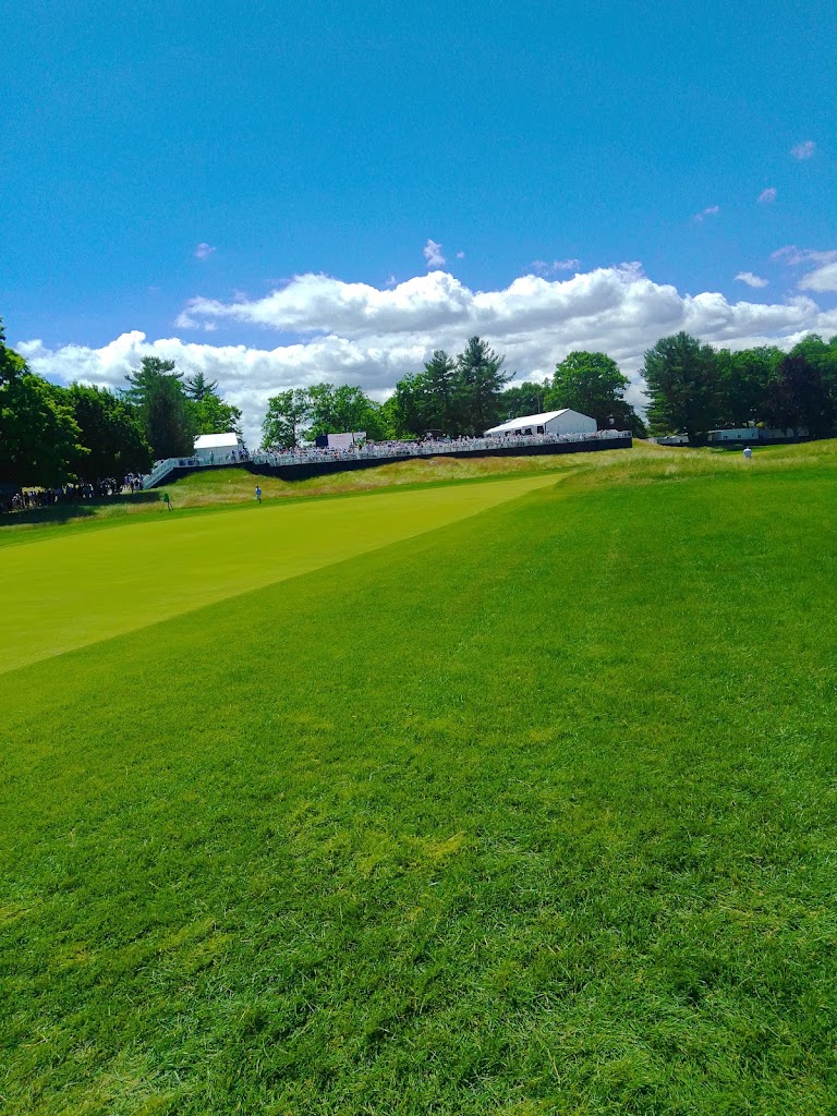 Panoramic view of a lush green golf course at The Country Club. Smooth