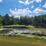 Panoramic view of a lush green golf course at The Course At Eagle Mountain. Smooth