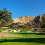 Panoramic view of a lush green golf course at The Course at Wente Vineyards. Smooth