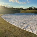 Panoramic view of a lush green golf course at The Courses at Andrews. Smooth