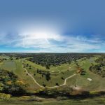 Panoramic view of a lush green golf course at The Courses at Watters Creek. Smooth