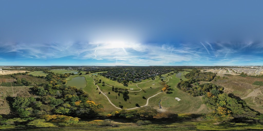 Panoramic view of a lush green golf course at The Courses at Watters Creek. Smooth