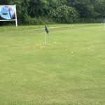 Panoramic view of a lush green golf course at The Courses of Clear Creek. Smooth