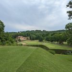 Panoramic view of a lush green golf course at The Cove Golf Course. Smooth