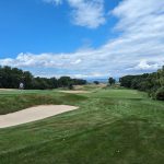 green grass with the flag in the hole.