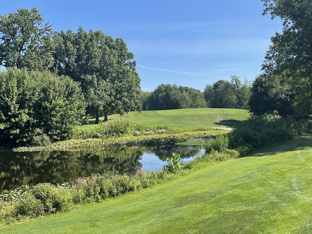 Panoramic view of a lush green golf course at The Fairways at Twin Lakes. Smooth
