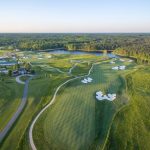 Panoramic view of a lush green golf course at The Federal Club Golf Course. Smooth