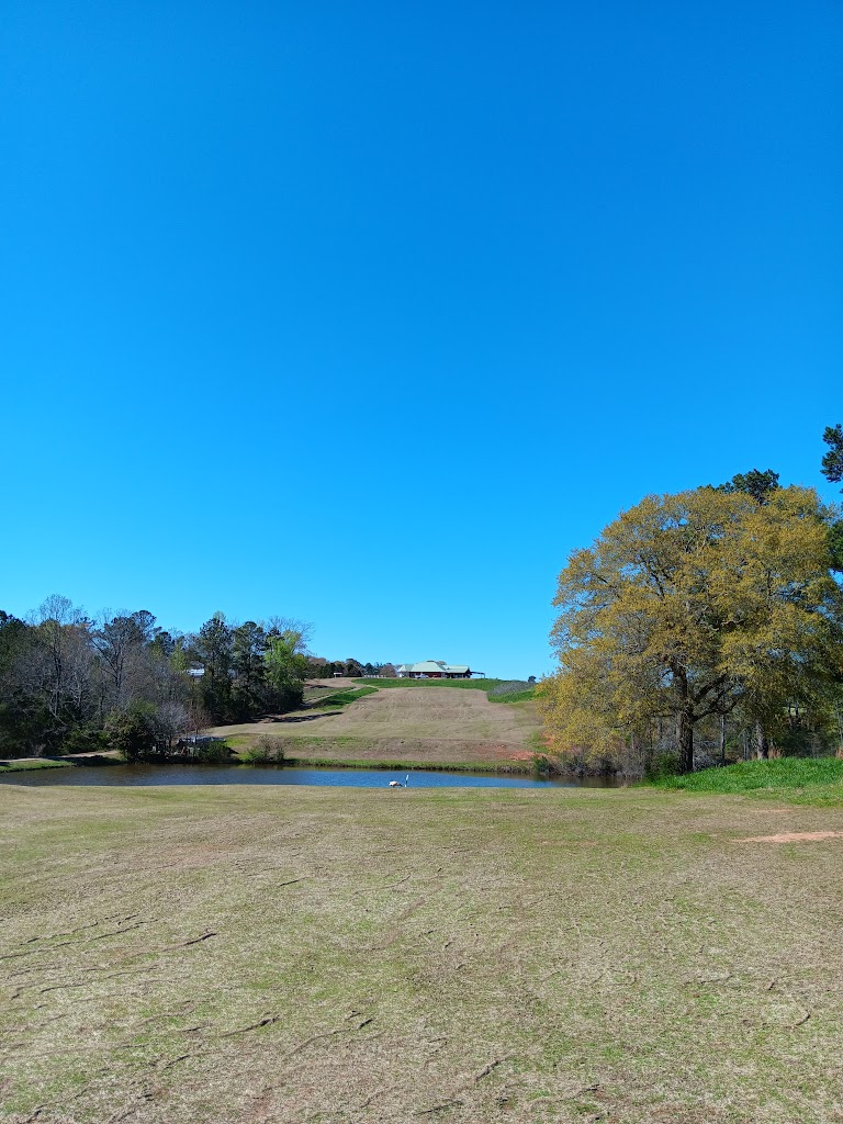 Panoramic view of a lush green golf course at The Fields Golf Club. Smooth