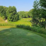 Panoramic view of a lush green golf course at The Fort Golf Resort. Smooth