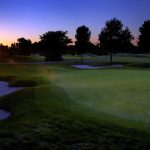 Panoramic view of a lush green golf course at The Fortress Golf Course. Smooth