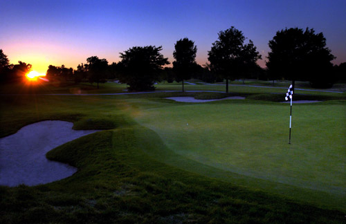 Panoramic view of a lush green golf course at The Fortress Golf Course. Smooth