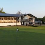 Panoramic view of a lush green golf course at The Freeport Club. Smooth