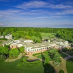 Panoramic view of a lush green golf course at The Georgia Club. Smooth