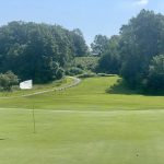 Panoramic view of a lush green golf course at The Golf Club At Camelot. Smooth