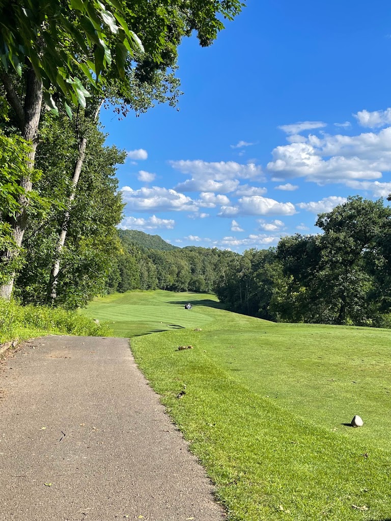 Panoramic view of a lush green golf course at The Golf Club at Cedar Creek. Smooth