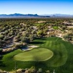 Panoramic view of a lush green golf course at The Golf Club at Dove Mountain. Smooth