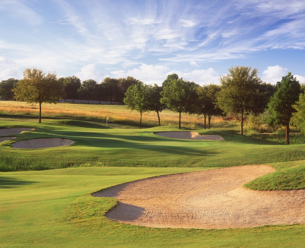 Panoramic view of a lush green golf course at The Golf Club at Fossil Creek. Smooth