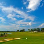 Panoramic view of a lush green golf course at The Golf Club at Hilton Head Lakes. Smooth