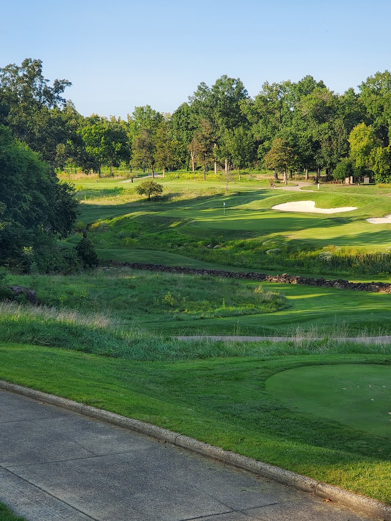 Panoramic view of a lush green golf course at The Golf Club at Lansdowne. Smooth