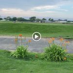 Panoramic view of a lush green golf course at The Golf Club at Middle Bay. Smooth