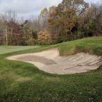 green grass with the flag in the hole.