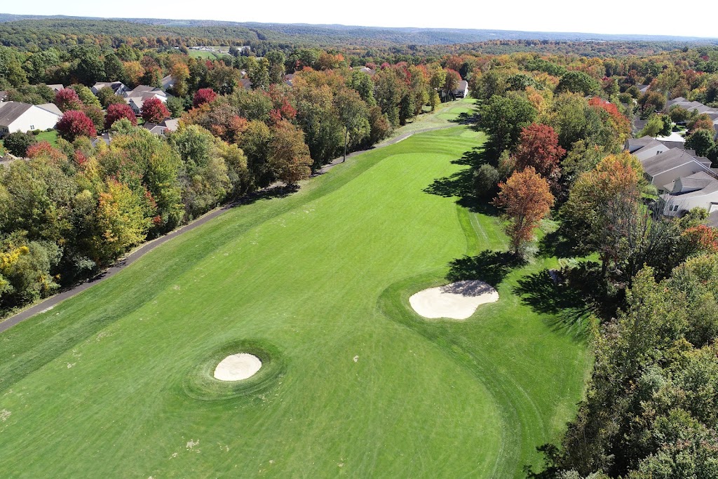 Panoramic view of a lush green golf course at The Golf Club at Oxford Greens. Smooth