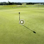 green grass with the flag in the hole.