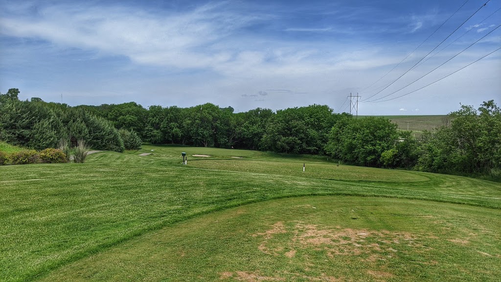 Panoramic view of a lush green golf course at The Golf Club at Table Creek. Smooth