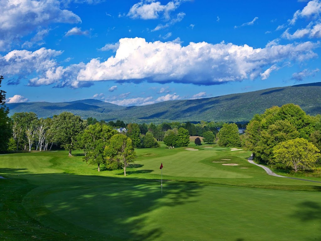 Panoramic view of a lush green golf course at The Golf Club at The Equinox. Smooth