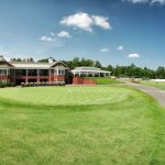 Panoramic view of a lush green golf course at The Golf Club at The Highlands. Smooth