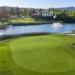 Panoramic view of a lush green golf course at The Golf Club of California. Smooth