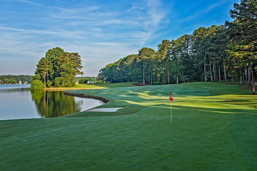 Panoramic view of a lush green golf course at The Golf Club of Georgia. Smooth