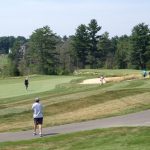 Panoramic view of a lush green golf course at The Golf Club of New England. Smooth