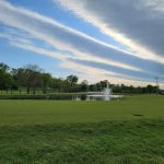 Panoramic view of a lush green golf course at The Governors Club. Smooth
