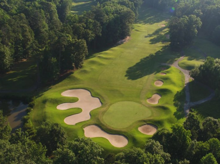 Panoramic view of a lush green golf course at The Green Course at Golden Horseshoe Golf Club. Smooth