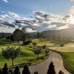 Panoramic view of a lush green golf course at The Greenbrier Golf Club. Smooth