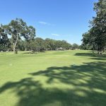 Panoramic view of a lush green golf course at The Greens at North Hills. Smooth