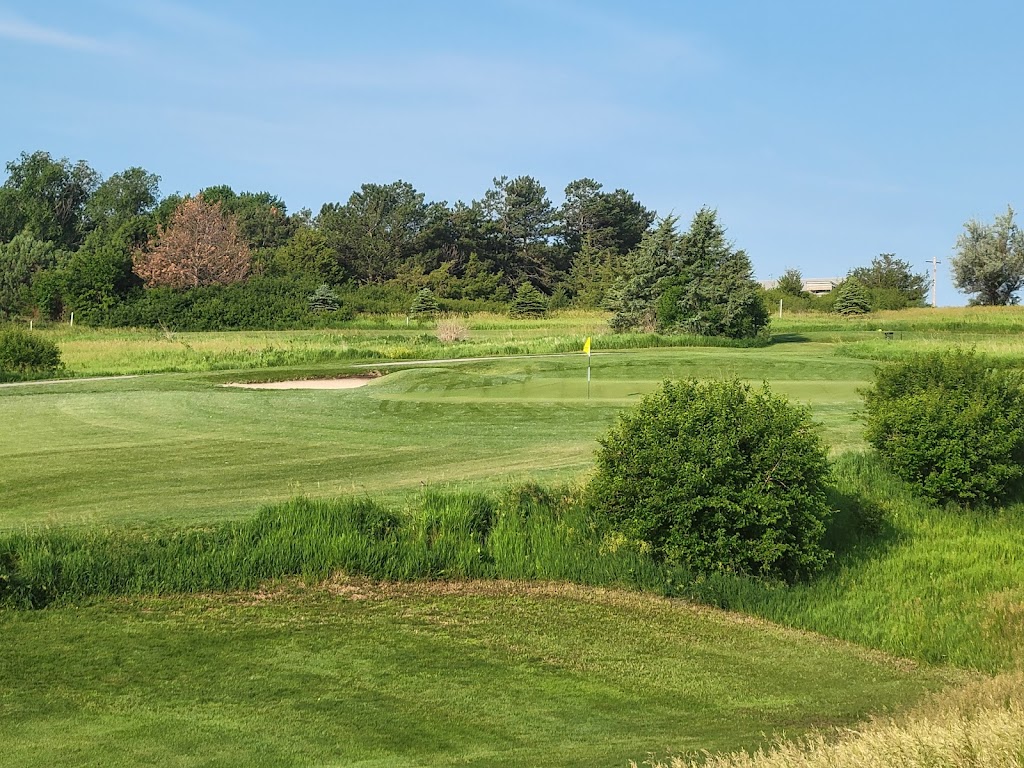 Panoramic view of a lush green golf course at The Greens at Prairie Hills. Smooth