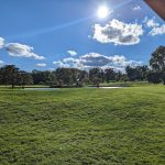 Panoramic view of a lush green golf course at The Hartford Golf Club. Smooth