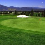 Panoramic view of a lush green golf course at The Highlands Golf Course. Smooth