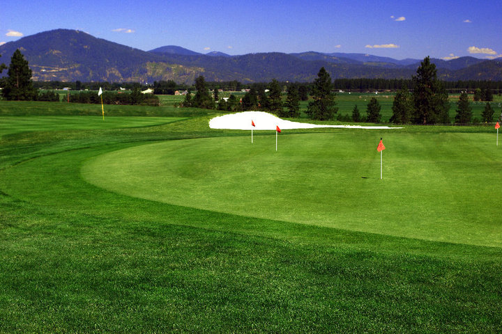 Panoramic view of a lush green golf course at The Highlands Golf Course. Smooth
